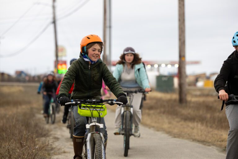 Caleb Rhodes pedals along the bike path in Nome.